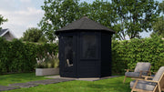 Black, hexagonal, wooden garden building with single door, side windows. Viewed from front/right side. 