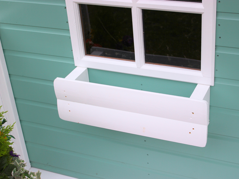 White window box on children's playhouse. 