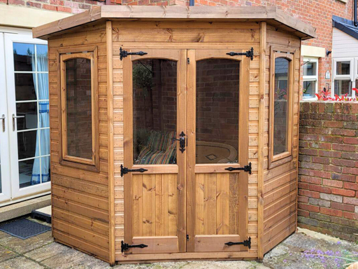 Beaumont Corner Summerhouse viewed from the front, featuring double doors and two opening side windows