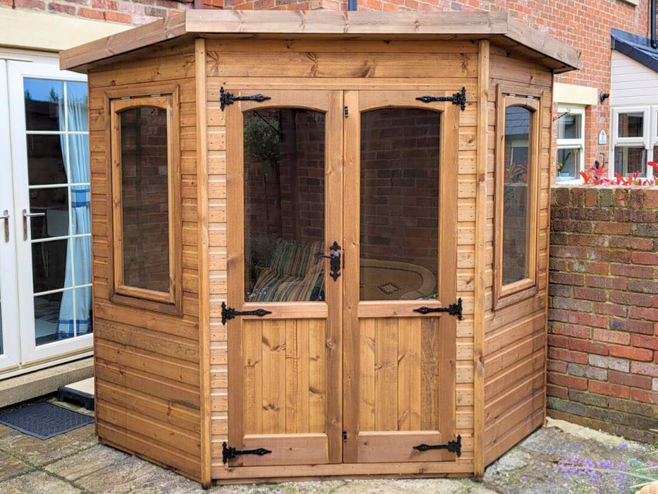Beaumont Corner Summerhouse viewed from the front, featuring double doors and two opening side windows