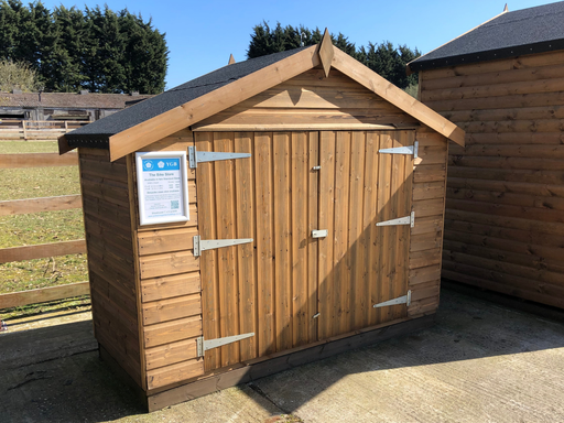 "The Bike Store" garden equipment and bike storage shed with double doors, viewed from the front at an angle to the left