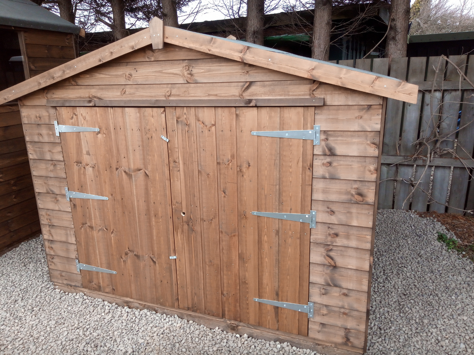 "The Bike Store" garden equipment and bike storage shed with double doors, viewed from the front at an angle to the right