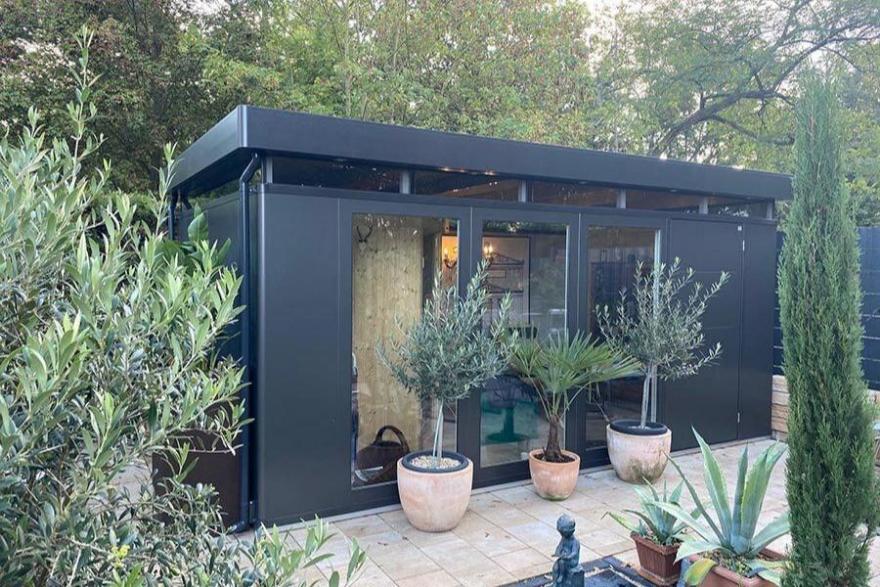 CasaNova steel garden building in a happy customer's garden in metallic dark grey finish