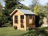 Wooden Summerhouse with large opening windows, single door with windows, viewed from right side. 
