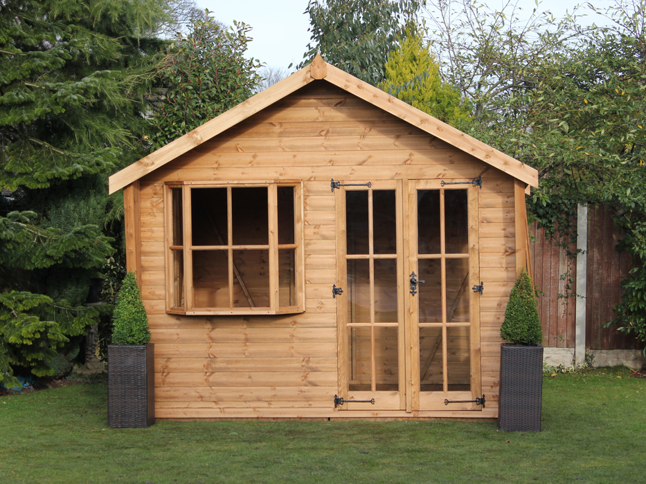Wooden Summerhouse with large bay window, double doors with windows, viewed from the front. 