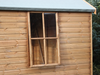 Close up side opening window on the side of the wooden summerhouse. 