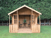 Wooden summerhouse with large double doors opened showing interior, viewed from the front. 
