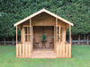 Wooden summerhouse with large double doors opened showing interior, viewed from the front. 