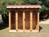 Wooden summerhouse with red roof tiles,  large double doors and front windows, viewed from the front. 