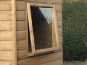 Close up of the side opening window on the right side of the corner shed. 