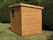 Classic wooden shed with single door and single front window, with pent style roof. Viewed from the right side. 
