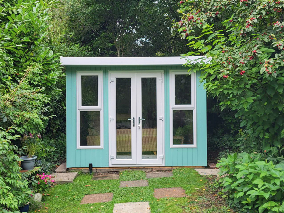 Deluxe Summerhouse / Office with UPVC double doors and two windows, painted in a blue / green finish and viewed from the front