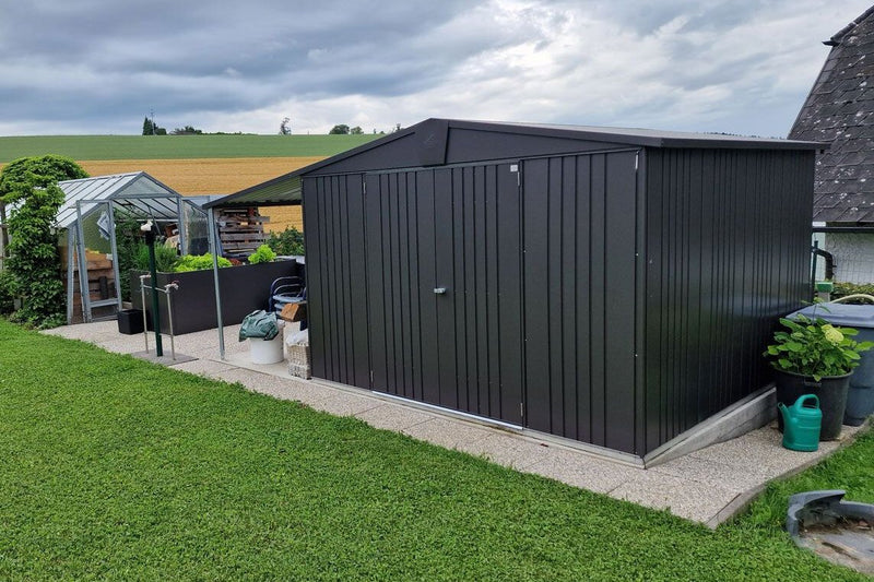Europa steel shed with an added canopy in a happy customer's garden