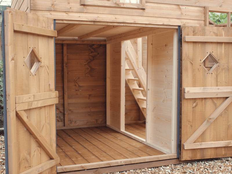Close up of shorter double doors opened, showing stairs in the interior and seperate rooms. 