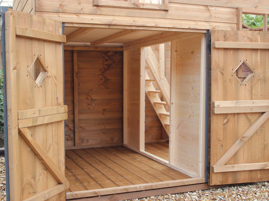 Close up of shorter double doors opened, showing stairs in the interior and seperate rooms. 