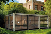 Large, open, wooden summerhouse with large windows surrounding. Viewed from the front/left side. 