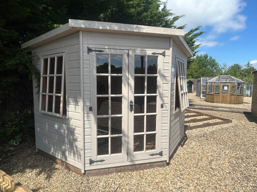 Georgian Corner Summerhouse with double doors and two opening side windows, painted white and viewed from the front