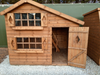 Harrison's Den two-storey children's playhouse with open door, viewed from the front