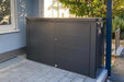 Highboard steel outdoor storage box in a happy customer's garden