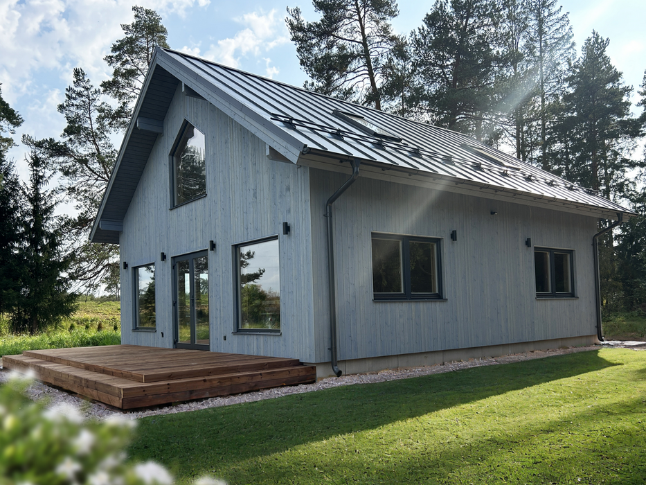 Lars two-storey residential log cabin, viewed from the left