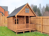 Laurie's Retreat two-storey children's playhouse with a veranda, in a natural timber finish, viewed from the left