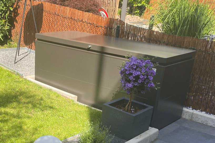 LoungeBox steel outdoor storage box in metallic dark grey finish in a happy customers garden