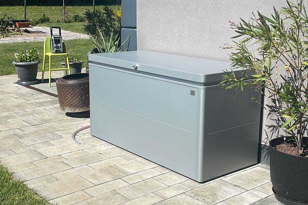 LoungeBox steel outdoor storage box in metallic silver finish in a happy customers garden