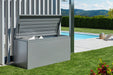 LoungeBox steel outdoor storage box in metallic quartz grey finish being used to store cushions by the side of a modern back garden pool