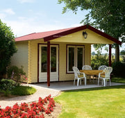 Large, wooden log cabin with red accents, double doors, front windows, front canopy are. Viewed from front/left side.