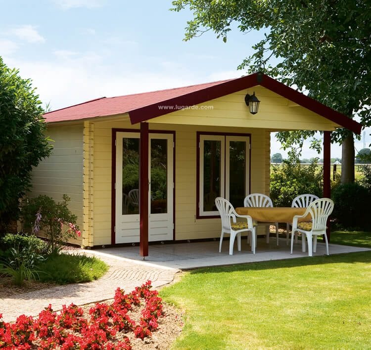 Large, wooden log cabin with red accents, double doors, front windows, front canopy are. Viewed from front/left side.