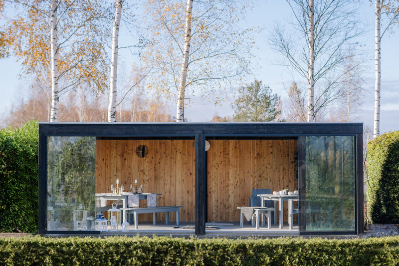 Large, open, wooden summerhouse with glass sliding doors. Viewed from the front. 