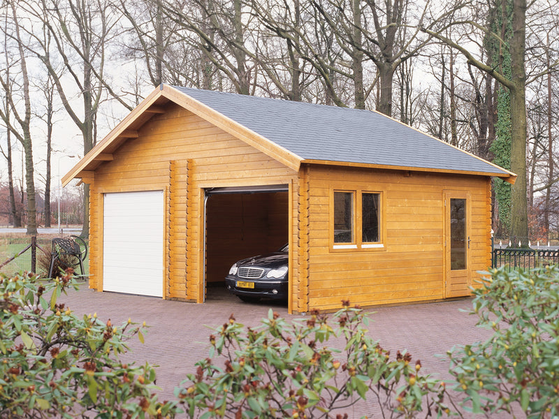 Large wooden garage with white door, side windows, side door, viewed from front/right side. 