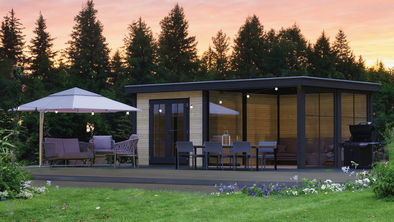 Large wooden summerhouse with double doors, large terrace area on right side. Viewed from the front/right side. 
