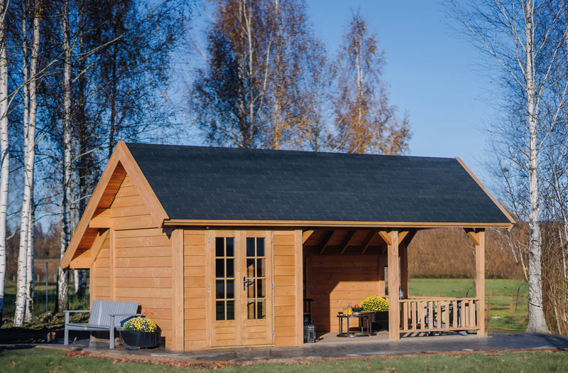 Large wooden summerhouse with double doors, patio area, viewed from the front/left side. 