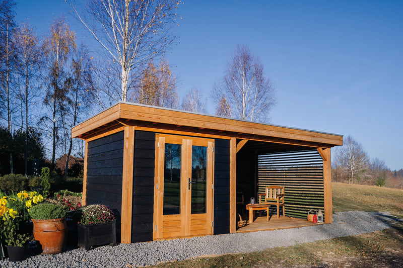 Large, black wooden summerhouse with double doors, canopy area on right side with slatted panels wall. Viewed from front/left side.