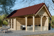 Large, wooden summerhouse with apex roof. double doors, red roof tiles, canopy on right side. Viewed from the right side. 
