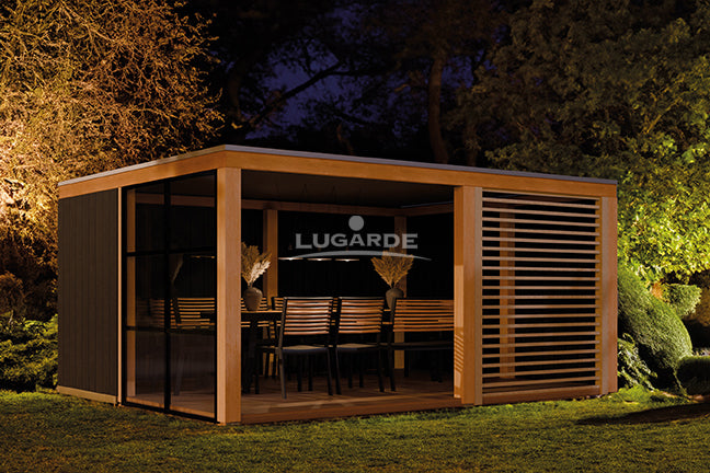 Large, open wooden summerhouse with glass wall, slatted pannels. Viewed from the front/left side.