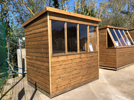 Lunar Potting Shed, in a natural timber finish, viewed from the left of the building