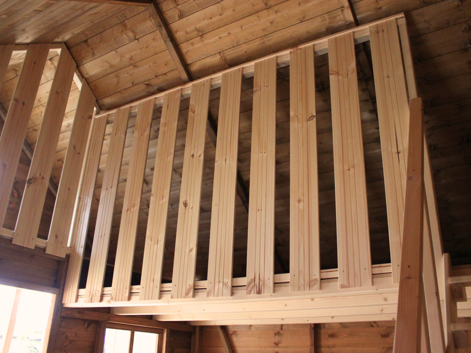 Interior of wooden playhouse, safety barrier of the second level. 