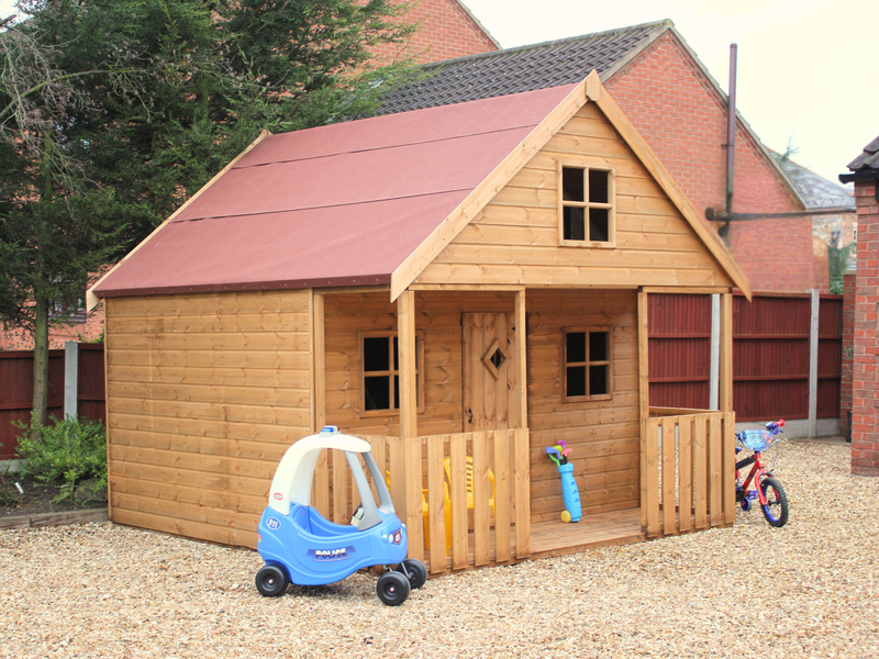 Large wooden playhouse with red roof, single door, multiple windows, viewed from the front/left side. 