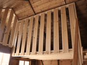 Interior of wooden playhouse, safety barrier of the second level. 