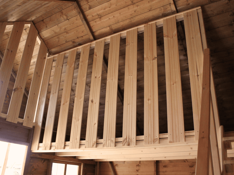Interior of wooden playhouse, safety barrier of the second level. 
