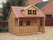 Wooden playhouse with 2 levels, red roof, single door, 4 front windows, viewed from front/left side.