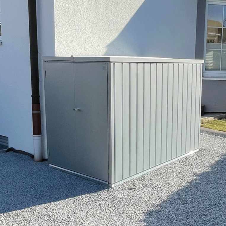 MiniGarage steel outdoor bike store in metallic silver finish in a happy customers garden