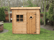 Wooden playhouse with single door and front window viewed from the front. 