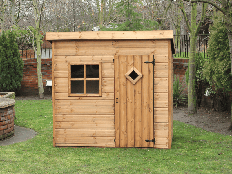 Wooden playhouse with single door and front window viewed from the front. 