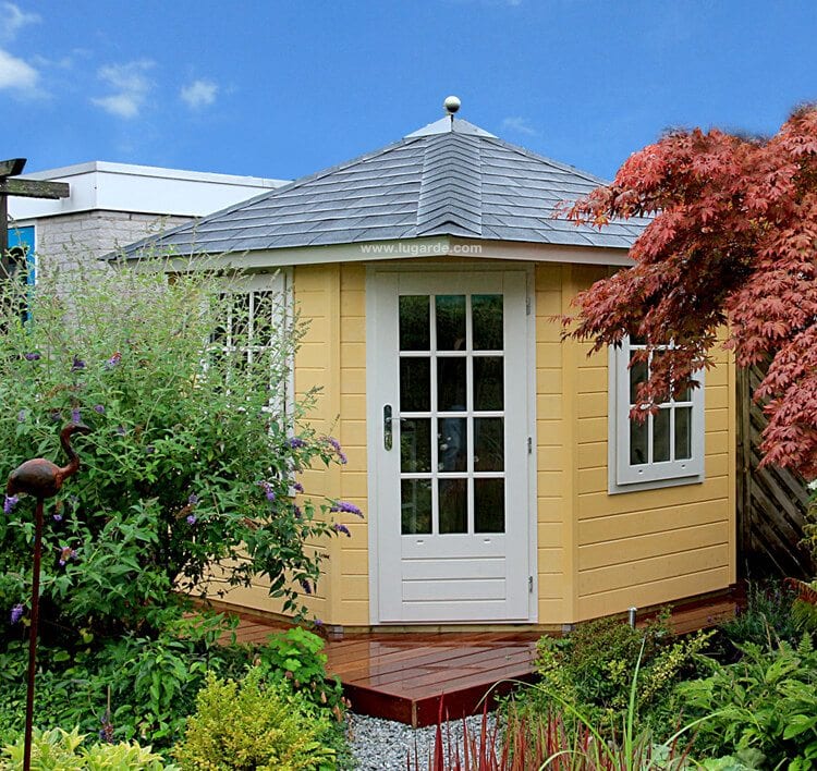 Wooden summerhouse painted yellow with white accents, single door at front and side windows. Viewed from the front. 