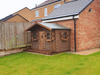 Parker's Cabin children's playhouse in a natural timber finish, viewed from the right