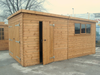 Pent style garage with large double doors, side door, three side windows, viewed from the right side. 