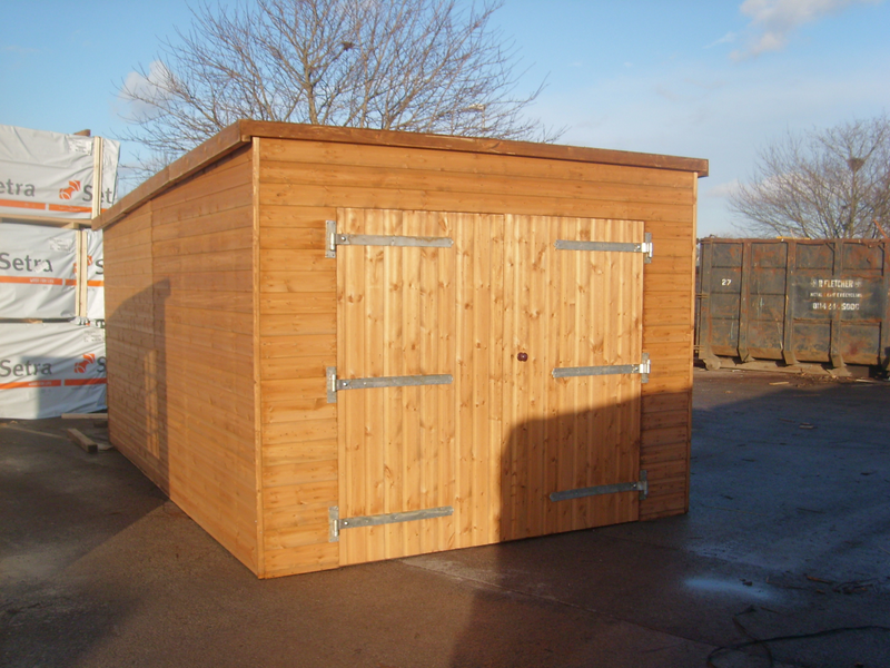 Pent style garage with large double doors viewed from the front. 